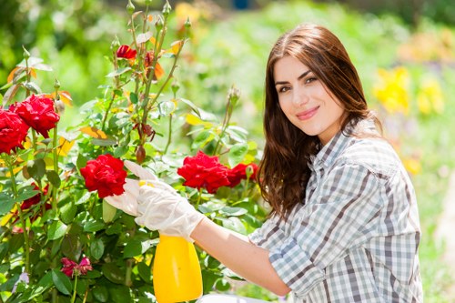 Gardener using safe lifting technique with garden materials